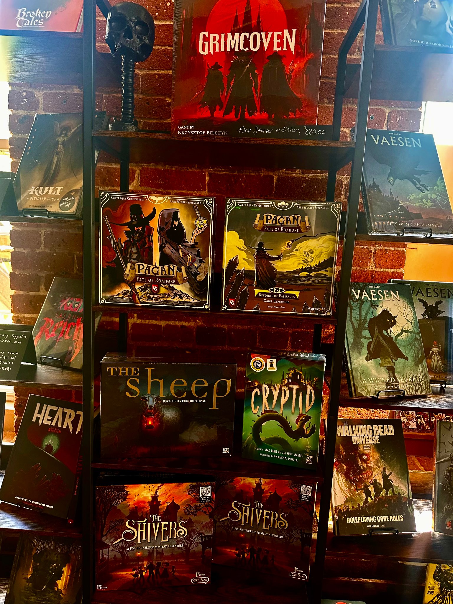 Horror board game shelf featuring Grimcoven, Pagan: Fate of Roanoke, The Sheep, Cryptid, and The Shivers